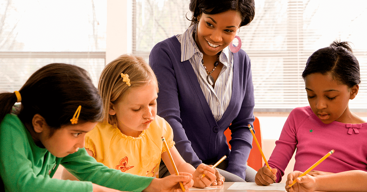 teacher with students doing work